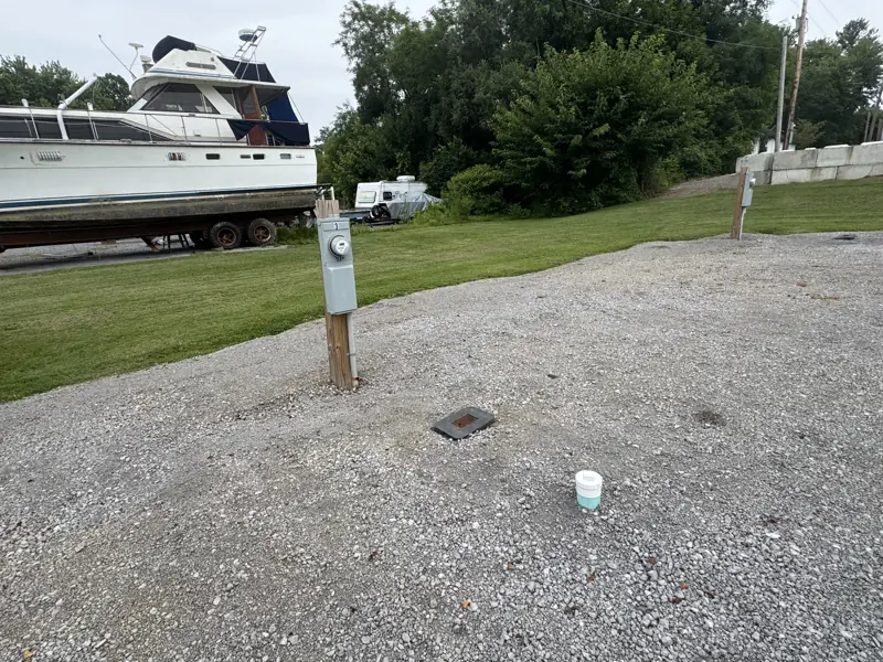 Gravel pad with pedestal beside a mowed lawn